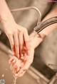 A woman washing her hands under a faucet. 