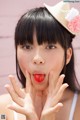 A woman with a straw hat on her head making a funny face.