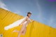 A woman in a white bikini jumping in the air.