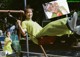 A woman sitting on a swing in a park.