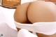 A woman in white stockings and stockings is laying on a bed.