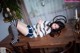 A woman laying on top of a wooden table.