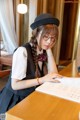 A woman sitting at a table reading a book.