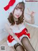 A woman in a santa claus outfit posing for the camera.