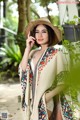 A woman wearing a straw hat and a colorful shawl.