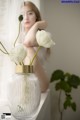 A vase with white flowers sitting on a window sill.