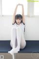 A woman sitting on top of a table with her legs up.