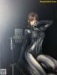 A woman in a black and silver spider suit posing for a picture.