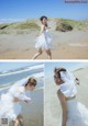 A woman in a wedding dress on the beach.